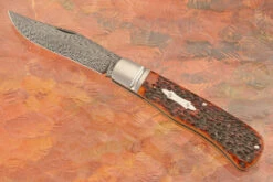 Feather Damascus Slipjoint Trapper With Amber Jigged Bone
